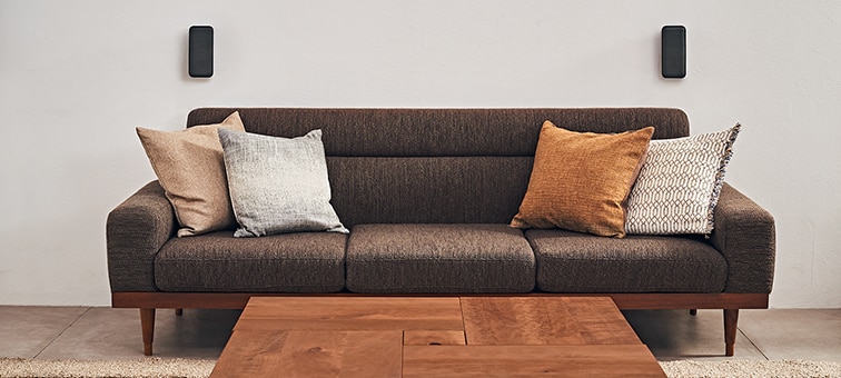 Sofa with wireless speakers behind